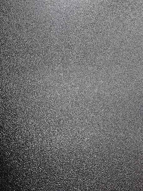 istock Close-up texture of dark rough surface with fine grain pattern. Perfect for abstract background, industrial design, or material texture reference. 2240037277