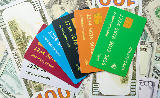 istock Credit Cards Placed Over Various US Dollar Denominations – Payment Method Concept 2240039527