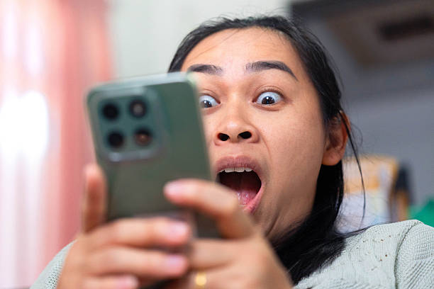 istock Asian Woman Shocked While Looking at Smartphone Screen 2240039836