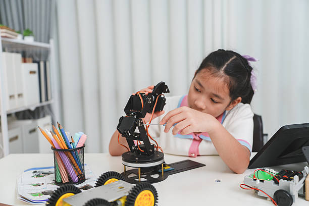 istock A young engineer uses a tool to build a robot. STEM and mechanics concept. 2240040706
