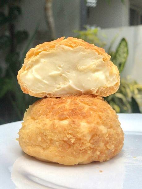 istock Golden choux au craquelin, featuring crisp pastry shells topped with a delicate, crumbly layer and filled with luscious cream. A delightful treat perfect for any indulgent moment. 2240040854
