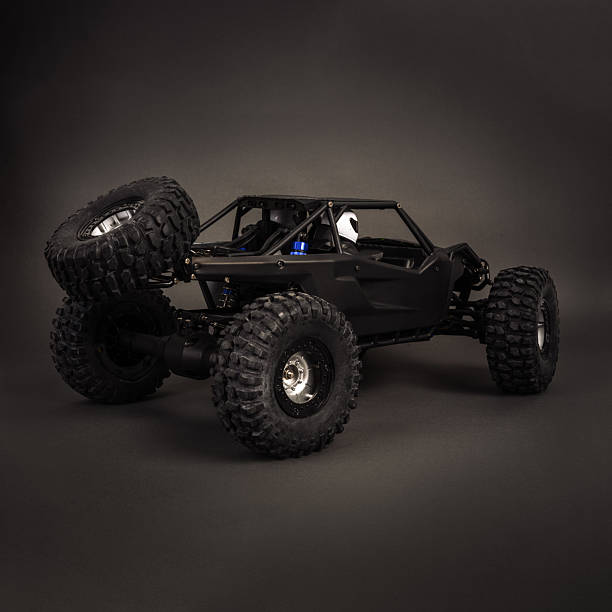 istock Radio-controlled car models: a little black buggy on a dark gray background. 2240043056