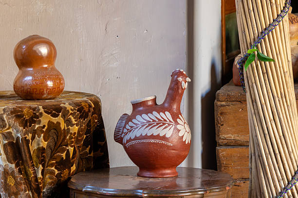 istock Oaxacan crafts A red and white ceramic vase with a chicken design sits on a table. Historic center of Queretaro, colonial architecture, decorations for the celebration of Mexico's Independence Day. 2240043685