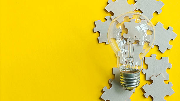 istock A light bulb on scattered puzzle pieces, symbolizing the bright idea, creativity, and the innovative solution to a complex problem with ample copy space on a vibrant yellow background. 2240046196