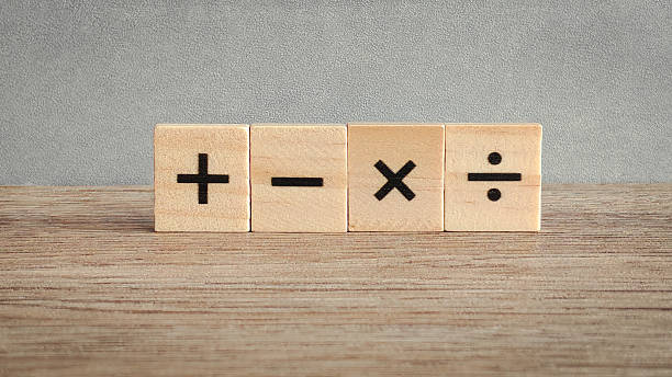 istock Four fundamental math operation signs on wooden blocks: addition, subtraction, multiplication, and division for education and business concepts. 2240046207