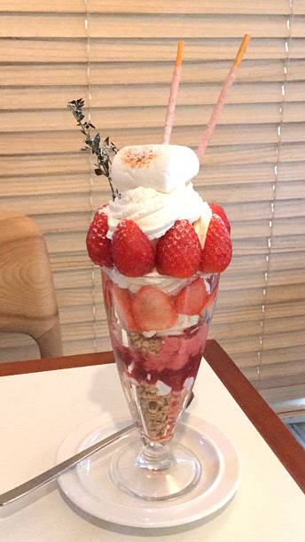 istock Healthy breakfast of strawberry parfait made with fresh fruit, and yogurt over a rustic white table. Selective focus with blurred background and foreground. 2240051542