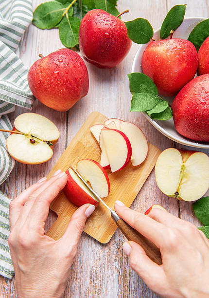 istock Cutting fresh red apples preparing healthy food 2240054743
