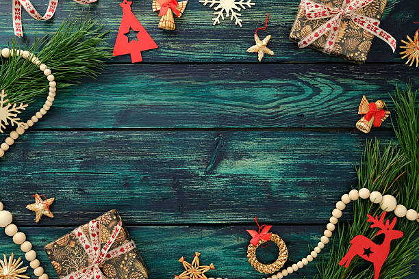istock Christmas flat lay with gift box, wooden ornaments, pine branches and festive decor on rustic teal background, perfect for holiday greeting or seasonal design. 2240055179