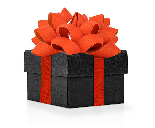 Elegant black gift box wrapped with a bright red ribbon and topped with a large decorative bow, isolated on a clean white background. The luxurious present design conveys sophistication and celebration, perfect for romantic occasions, anniversaries, Christmas, Valentine’s Day, or corporate gifts. Ideal for advertising, e-commerce, packaging design, and festive visuals emphasizing elegance and style.