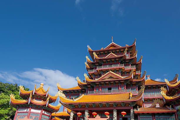 istock Traditional Chinese Temple Architecture with Ornate Roofs and Red Pillars Under a Clear Blue Sky 2240056772