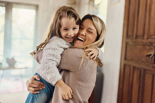 istock Happy single mother and daughter embracing at home. 2240057728