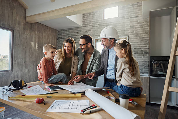 istock Happy family and architect talking about plans during home renovation process. 2240058452