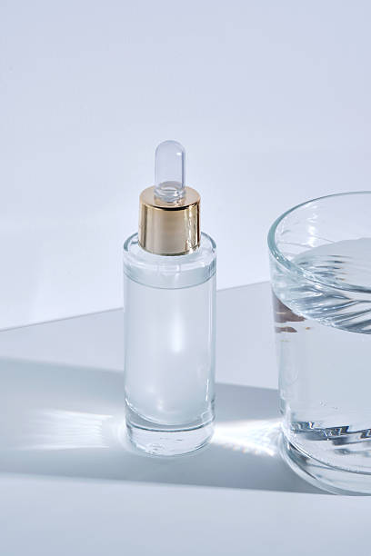 istock Bottle with serum on a white background with glare from water. 2240060465
