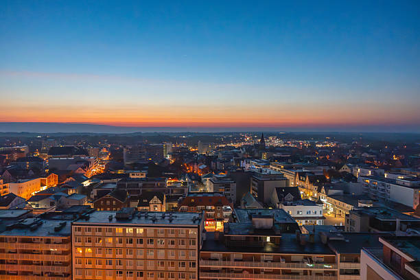 istock A cityscape at dusk glows with lights under a blue-orange sky. 2240061330