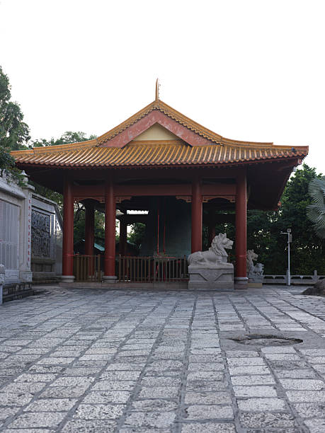istock Traditional Chinese Pavilion with Stone Lion Statues in a Serene Courtyard Setting 2240061442