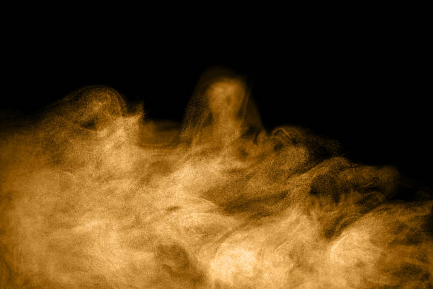 istock Golden dust and smoke texture on black background, perfect for mystical design, light particle effect, energy motion art, abstract composition, and visual effects background concept. brown dust smoke 2240061468