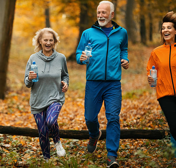 istock Group of mature folks jogging in a forest. 2240062310