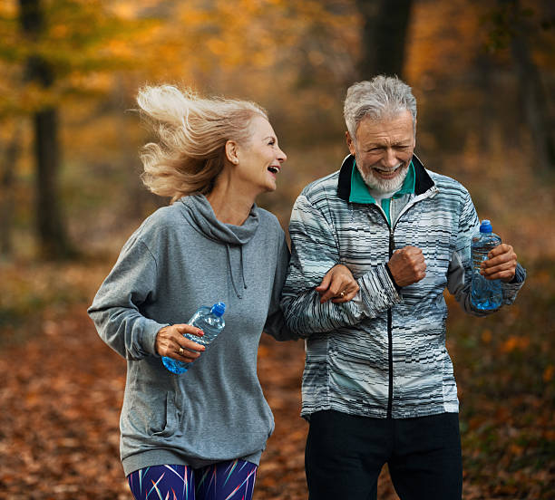 istock Group of mature folks jogging in a forest. 2240062362