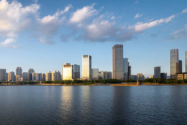 istock Modern City Skyline with Reflective Lake View at Golden Hour 2240064368