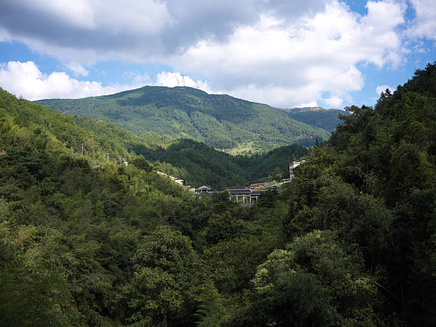 istock A Scenic Valley Surrounded by Lush Green Mountains Under a Cloudy Sky 2240064497