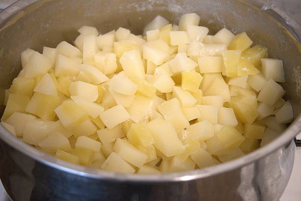 istock Cubed boiled potatoes in cooking pan, close-up 2240064613