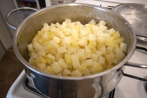 istock Cubed boiled potatoes in cooking pan, close-up 2240064615