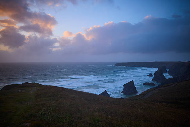 Dramatic sky, Sunset above the Bedrutheran Steps in Cornwall, England, UK