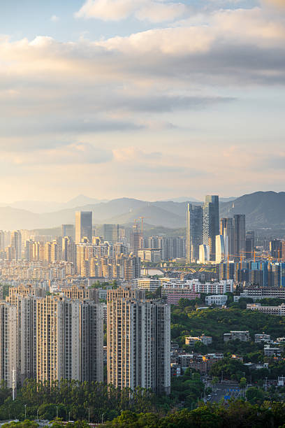 istock Urban Skyline and Modern Architectural Complex with High-Rise Buildings and Distant Mountains Under a Cloudy Sky 2240065992