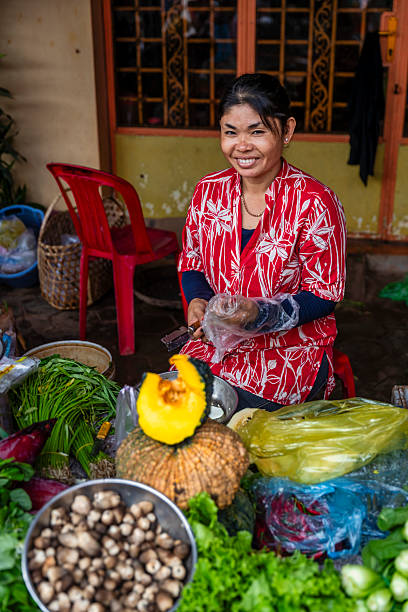 istock Cambodian woman selling fresh vegetables, Cambodia 2240066314