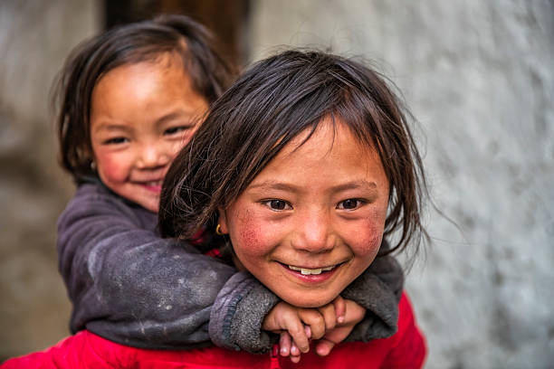 Two Tibetan young girls from Lo Manthang, Upper Mustang. Mustang region is the former Kingdom of Lo and now part of Nepal,  in the north-central part of that country, bordering the People's Republic of China on the Tibetan plateau between the Nepalese provinces of Dolpo and Manang.
