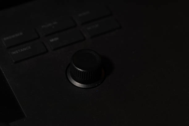 istock Close-up of a Knob and Buttons on a Black Electronic Device in Low Light 2240066511