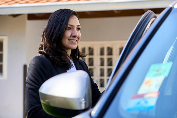 istock Woman smiling getting into car for morning commute 2240066733
