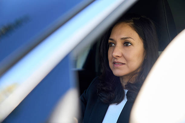 istock Professional woman driving car, commuting to work thoughtfully 2240066818