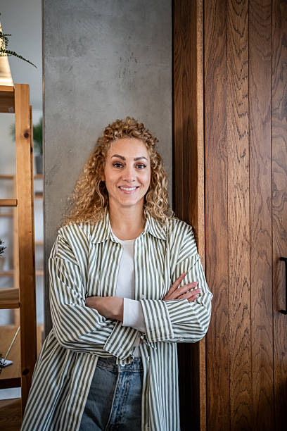 istock Confident female entrepreneur standing with crossed arms 2240066996