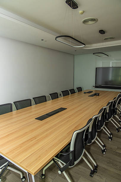 istock Modern Conference Room Interior with Long Wooden Table and Ergonomic Chairs Arranged for Professional Meetings 2240067374