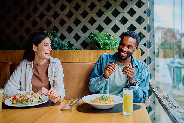 istock Diverse friends laughing enjoying lunch in restaurant 2240068122