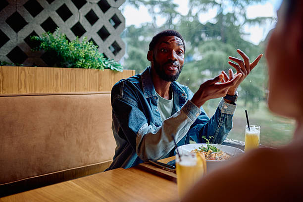 istock African American man talking gesturing during restaurant discussion 2240068493