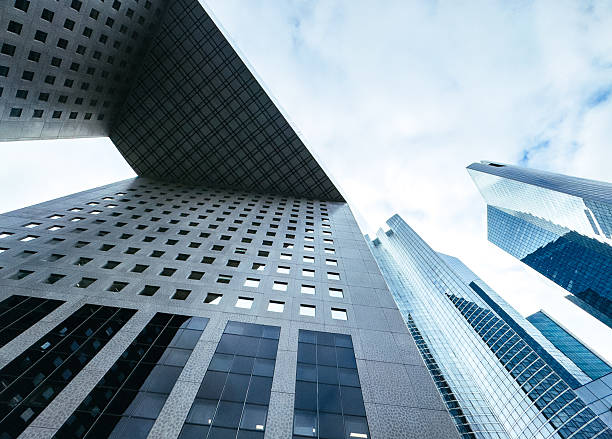 Modern glass office buildings in blue tones, photographed from low angle