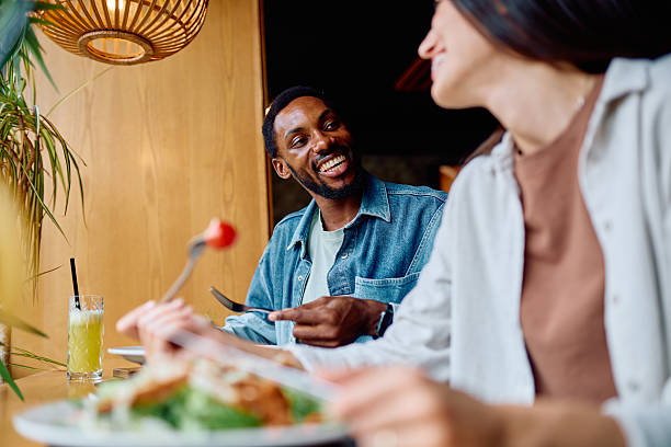 istock Interracial couple smiling and sharing a romantic date 2240068992