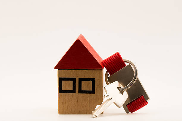 istock Wooden house and a key 2240069068