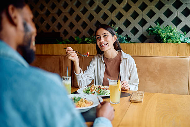 istock Diverse couple enjoying lunch together at restaurant 2240069102