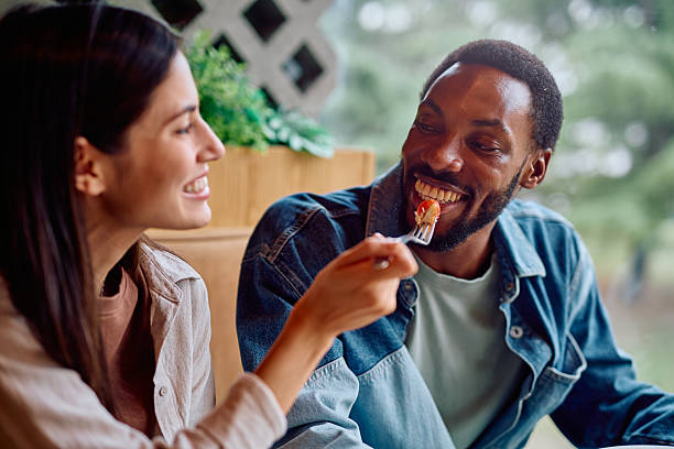istock Couple sharing food enjoying intimate restaurant date 2240069269