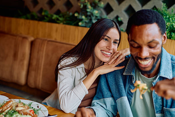 istock Happy interracial couple enjoying a romantic restaurant date 2240069314
