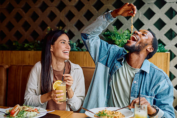 istock Happy multiracial couple enjoying pasta dinner date 2240069351