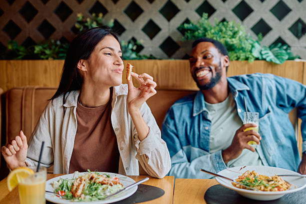 istock Interracial couple enjoying restaurant meal on a date 2240069393