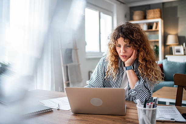 istock Woman working from home feeling stressed by problems on laptop 2240069575
