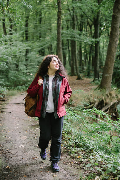 istock Teenage daughter smiling while hiking in forest 2240070079