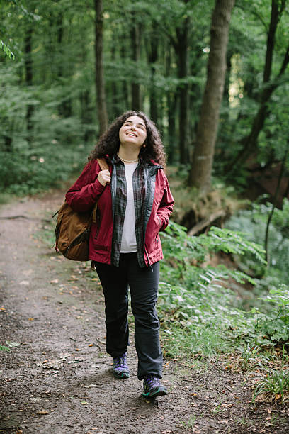 istock Young woman hiking in green summer forest 2240070083
