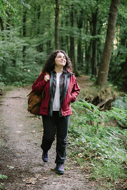 istock Young woman enjoying forest hiking adventure 2240070086