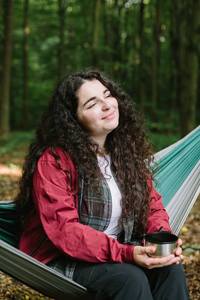 istock Woman relaxing in a hammock enjoying forest peace 2240070147